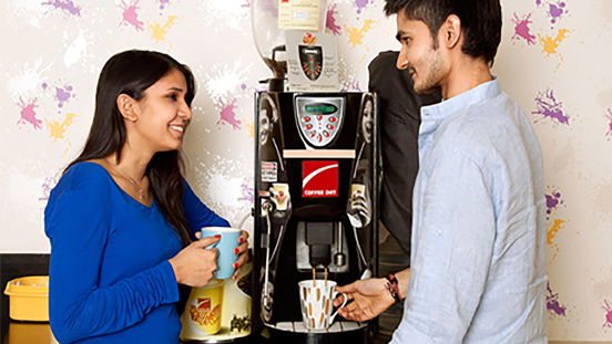 Students share a cup of tea and a conversation in the commons area.