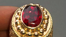 Bright red faceted ruby in a gold ring, from the large and potentially productive Snezhnoe deposit in Tajikistan. Bright red faceted ruby in a gold ring, from the large and potentially productive Snezhnoe deposit in Tajikistan.