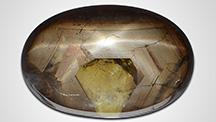 Sapphire cabochon displaying asterism. Sapphire cabochon displaying asterism.