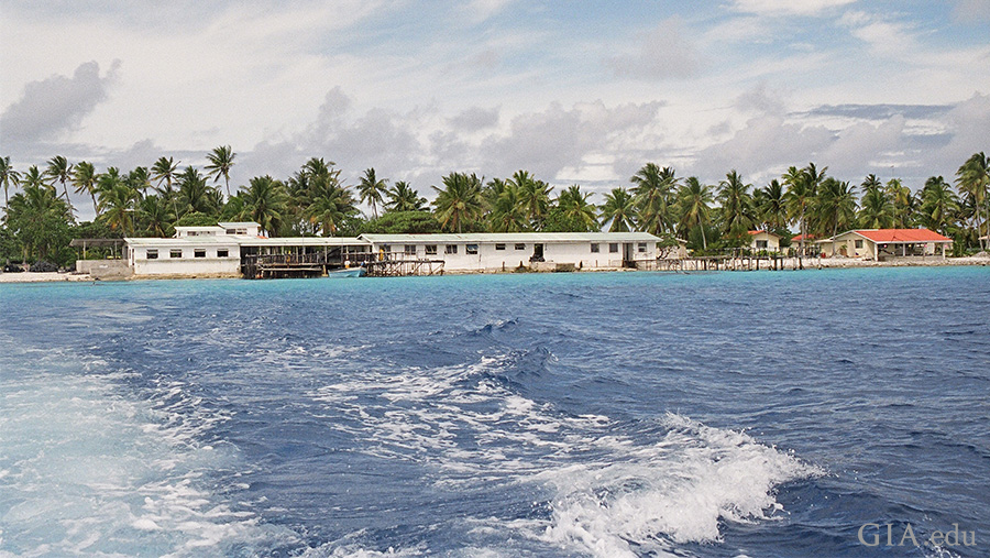 Landscape of French Polynesia's atolls shielding pearl farms, where the June birthstone is found, from surrounding ocean waves. The land is lined with palm trees, sheltering a lagoon that's ideal for mollusk culturing. Landscape of French Polynesia's atolls shielding pearl farms, where the June birthstone is found, from surrounding ocean waves. The land is lined with palm trees, sheltering a lagoon that's ideal for mollusk culturing.