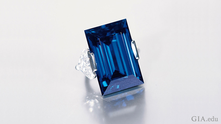 The famed Rockefeller Sapphire weighs 62.02 carats and is flanked by two cut-cornered triangular cut diamonds, mounted in a platinum ring to show off the blue September birthstone. The famed Rockefeller Sapphire weighs 62.02 carats and is flanked by two cut-cornered triangular cut diamonds, mounted in a platinum ring to show off the blue September birthstone.