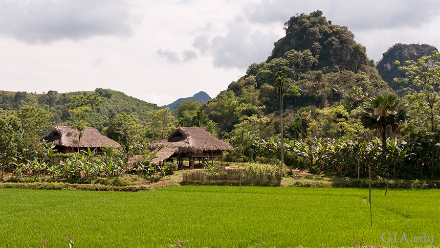 Landscape of a small village surrounded by greenery at the base of the mountains in the Luc Yen region where the July birthstone, ruby is found. Landscape of a small village surrounded by greenery at the base of the mountains in the Luc Yen region where the July birthstone, ruby is found.
