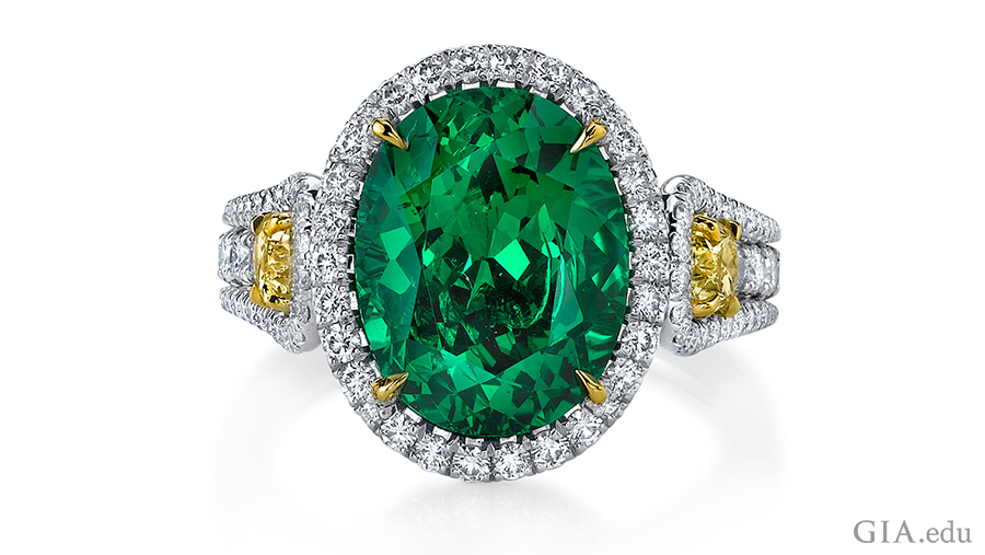 5.55 carat oval cut tsavorite garnet ring set in platinum with two fancy yellow diamonds and 136 round diamonds shows off the January birthstone. 5.55 carat oval cut tsavorite garnet ring set in platinum with two fancy yellow diamonds and 136 round diamonds shows off the January birthstone.