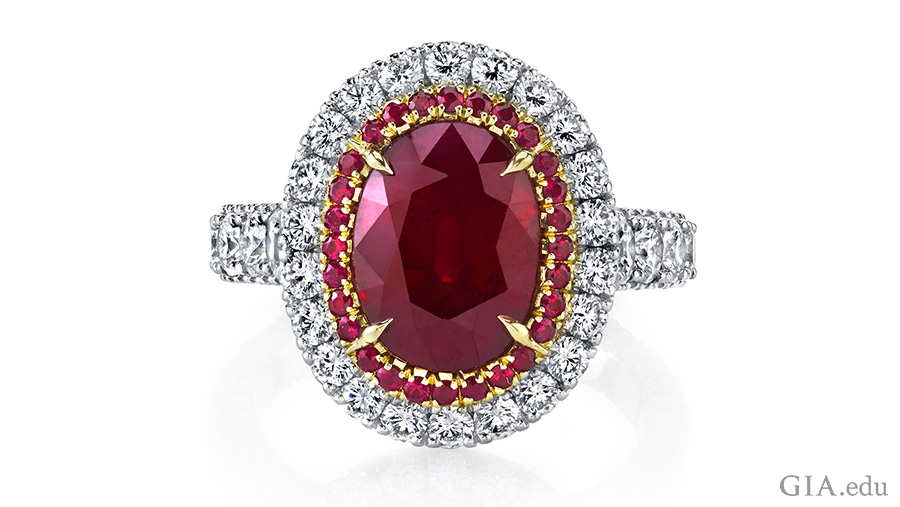 A 5 carat oval ruby is the focal point of a ring set in platinum with 18k rose gold, surrounded by halos of round rubies and diamonds. A 5 carat oval ruby is the focal point of a ring set in platinum with 18k rose gold, surrounded by halos of round rubies and diamonds.
