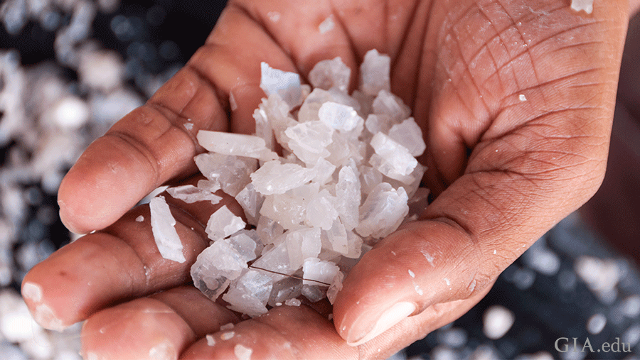 Hand holding pile of rough moonstone, the June birthstone, found in Sri Lanka. Hand holding pile of rough moonstone, the June birthstone, found in Sri Lanka.