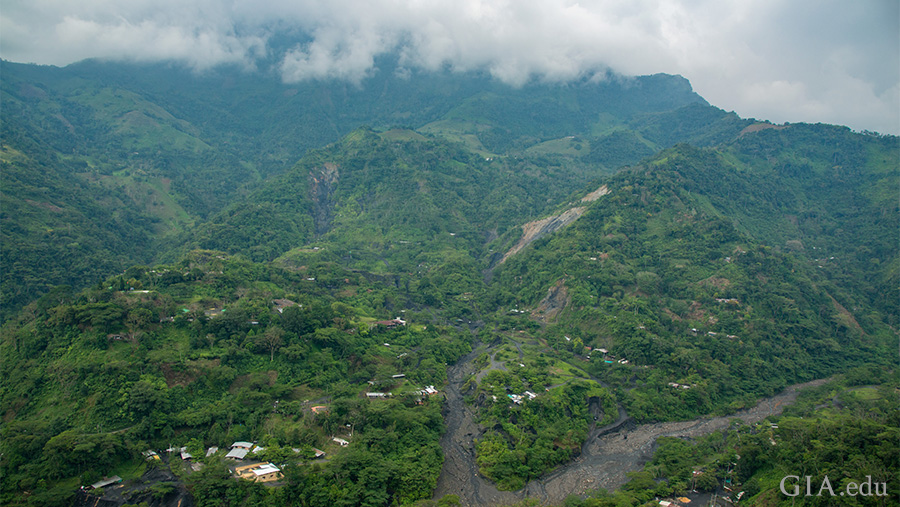 The May birthstone, emerald, is found in the landscape of the lush green Andes Mountains towering over the deep tropical valleys around Muzo. The May birthstone, emerald, is found in the landscape of the lush green Andes Mountains towering over the deep tropical valleys around Muzo.