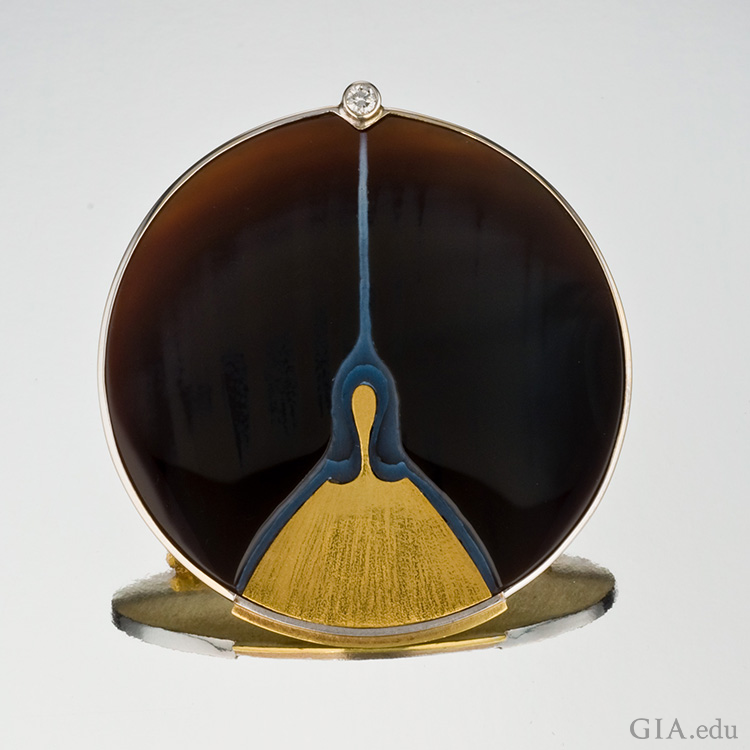 A sardonyx picture brooch with gold and platinum has a single diamond on top, showing off the August birthstone. A sardonyx picture brooch with gold and platinum has a single diamond on top, showing off the August birthstone.